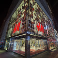 Glass floor with reflective surface and red text in an indoor setting